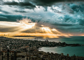 Dramatic sky and sunset over Beirut City and it's Mediterranean sea. Shot taken from a vintage point above Jounieh bay seen in the foreground.